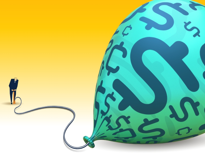 man pumping up balloon decorated with money symbols
